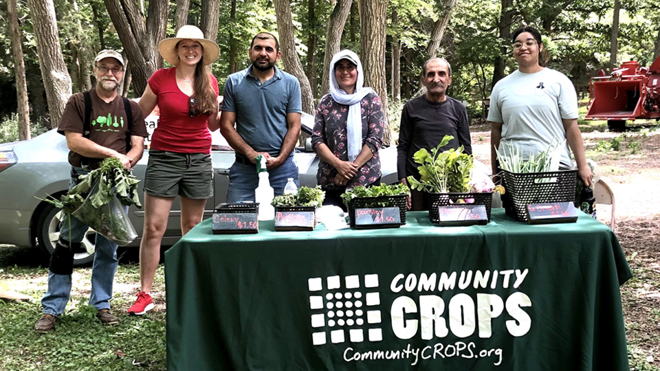 Community Crops table with Gwyneth Talley and students
