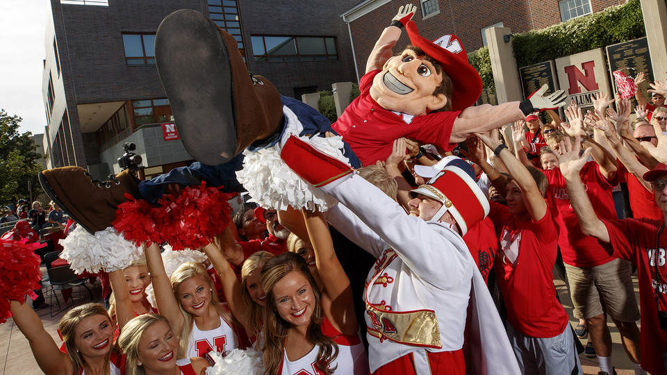 Photo Credit: Herbie Husker being lifted up by crowd