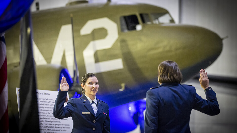 Photo Credit: Second Lt. Isabel Welch recites the Oath of Office as directed by Air Force Major Nicole Beebe on May 16.
