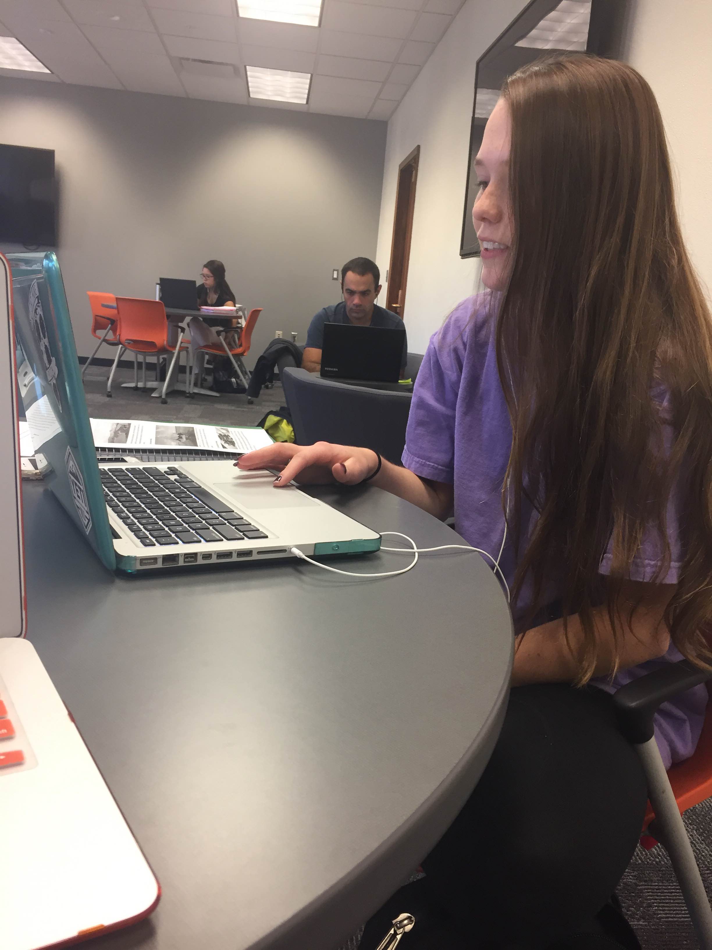 Photo Credit: Junior Kaiti Hill talks to her Skype partner about the assigned article about ecotourism in Latin America