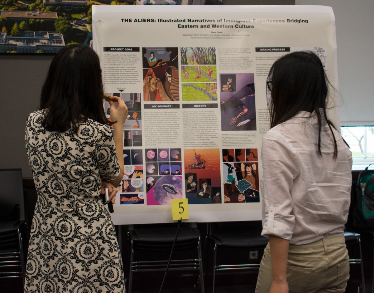 Photo Credit: Female students in front of research poster