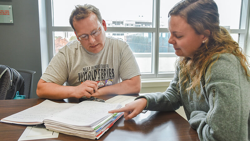 Student helping another with work