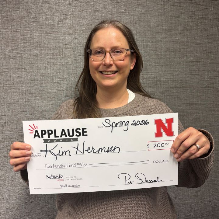 Kim Hermsen holding an Applause check