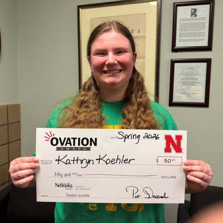 Kathryn Koehler holding an Applause check