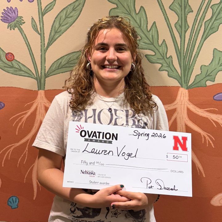 Lauren Vogel holding an Ovation check