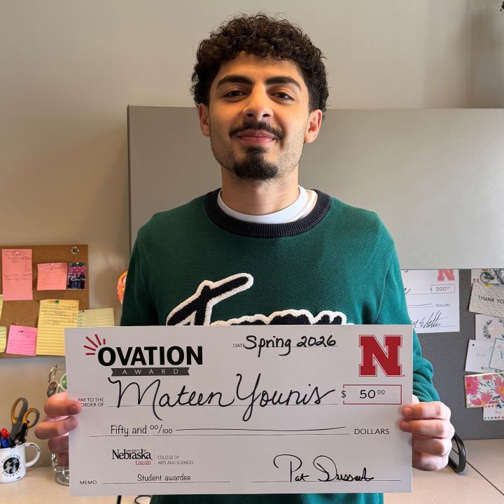 Mateen Younis holding an Ovation check