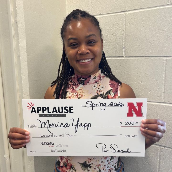 Monica Yapp holding a large Applause check