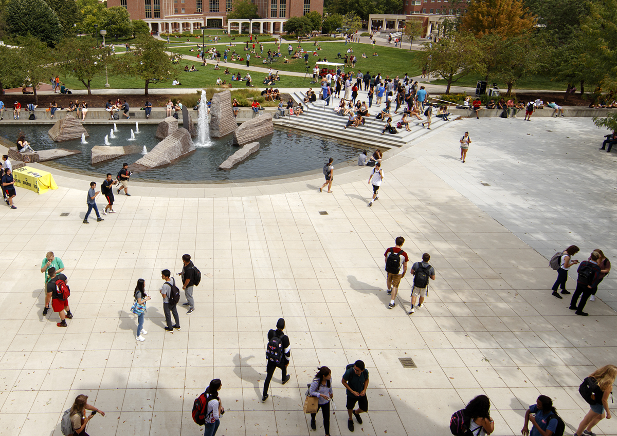 Students on campus near fountain