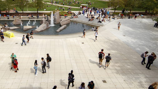 Students on campus near fountain
