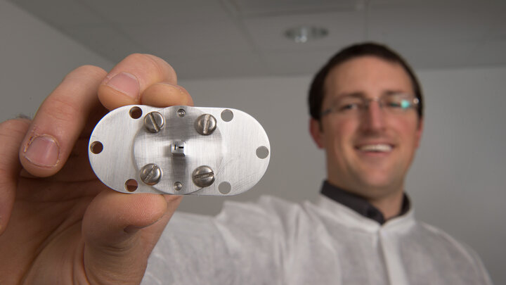 doctoral student Nathan Powers displaying the accelerator used to create synchrotron X-rays