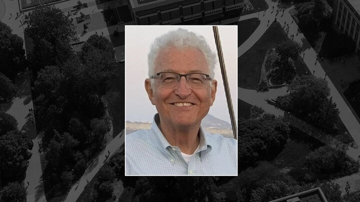 Color portrait of James E. Ford on black campus background