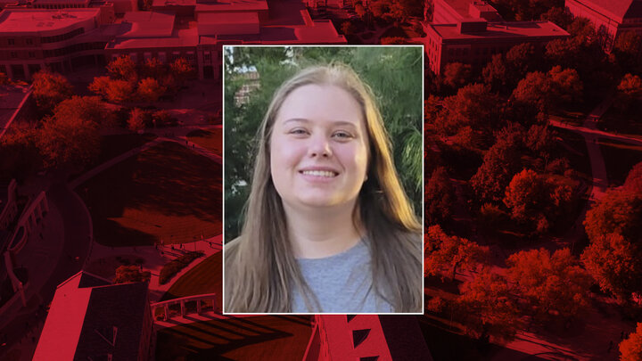 Color portrait of Francine Mace on red campus background