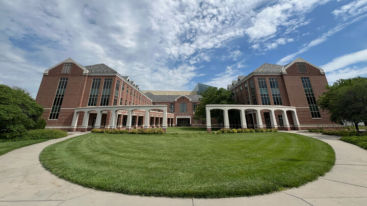 An exterior photo of the south side of the Kauffman Academic Residential Center on a partly cloudy day.