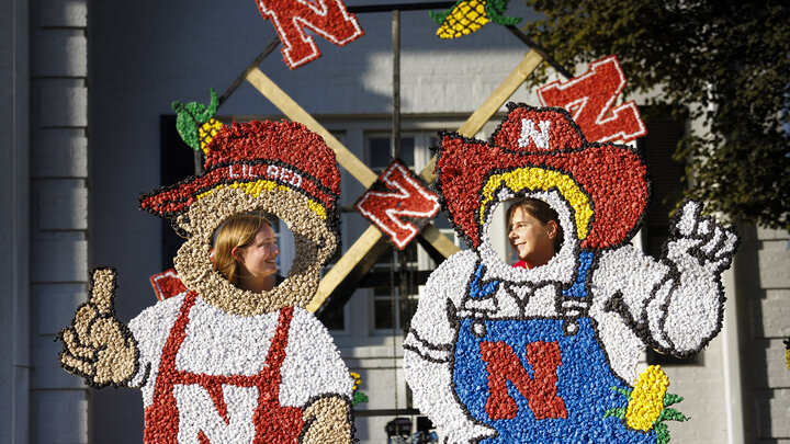 Sydney Honaker and Abby Veiman try out the Lil Red and Herbie lawn decorations in front of the Phi Kappa Psi fraternity house during Homecoming festivities Oct. 4.