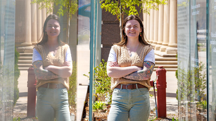 Emily Caldwell stands near a military memorial on campus.