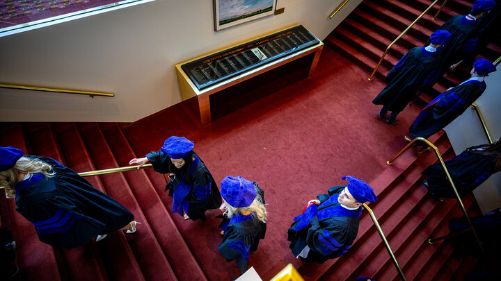 College of Law graduates climb the red staircase in the Lied Center for Performing Arts prior to ceremonies May 3.