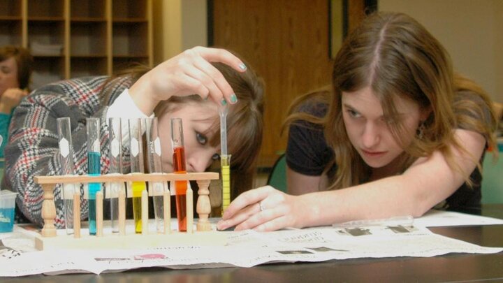 Women studying scientific equipment