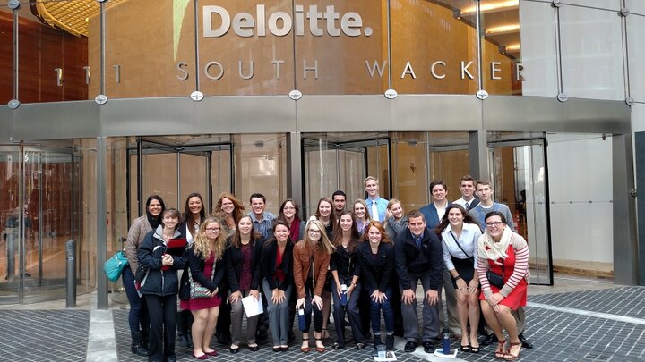 Students in the business learning community pose outside the Chicago office of Deloitte during the 2015 Big Trip.