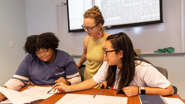 Katrina Jagodinsky, Rosowski associate professor of history, works with undergraduate researchers Kasha Appleton and Natalie Lucas.