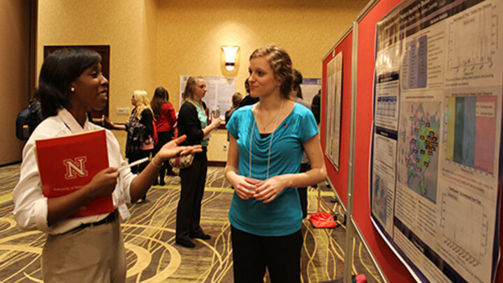 Students discuss their research during a poster session at the 2014 Nebraska Conference for Undergraduate Women in Mathematics.