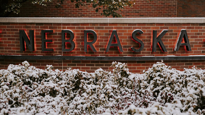 Nebraska in red letters on brick wall at Van Brunt center