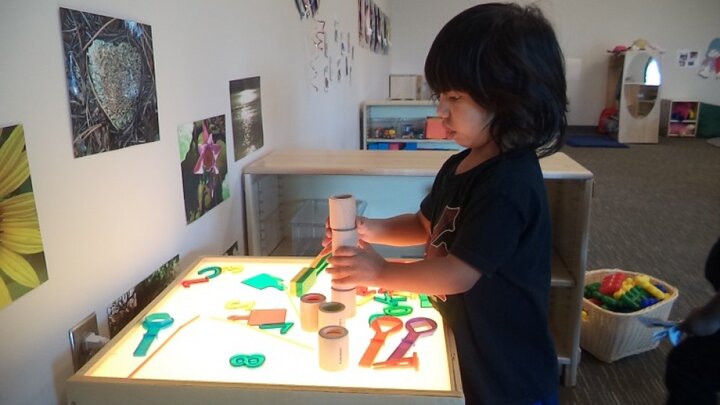 Child playing with toys in a room