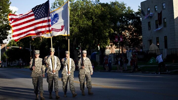 ROTC cadets holding an American flag