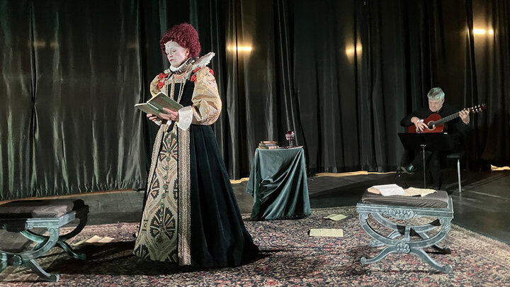 An actress is in full monarchy regalia as Queen Elizabeth I.